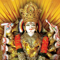 Decorative statue of a deity with intricate gold and red attire against a yellow background