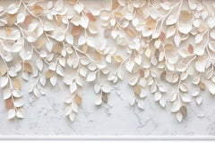 Decorative wall art with white and gold leaves on a marble background