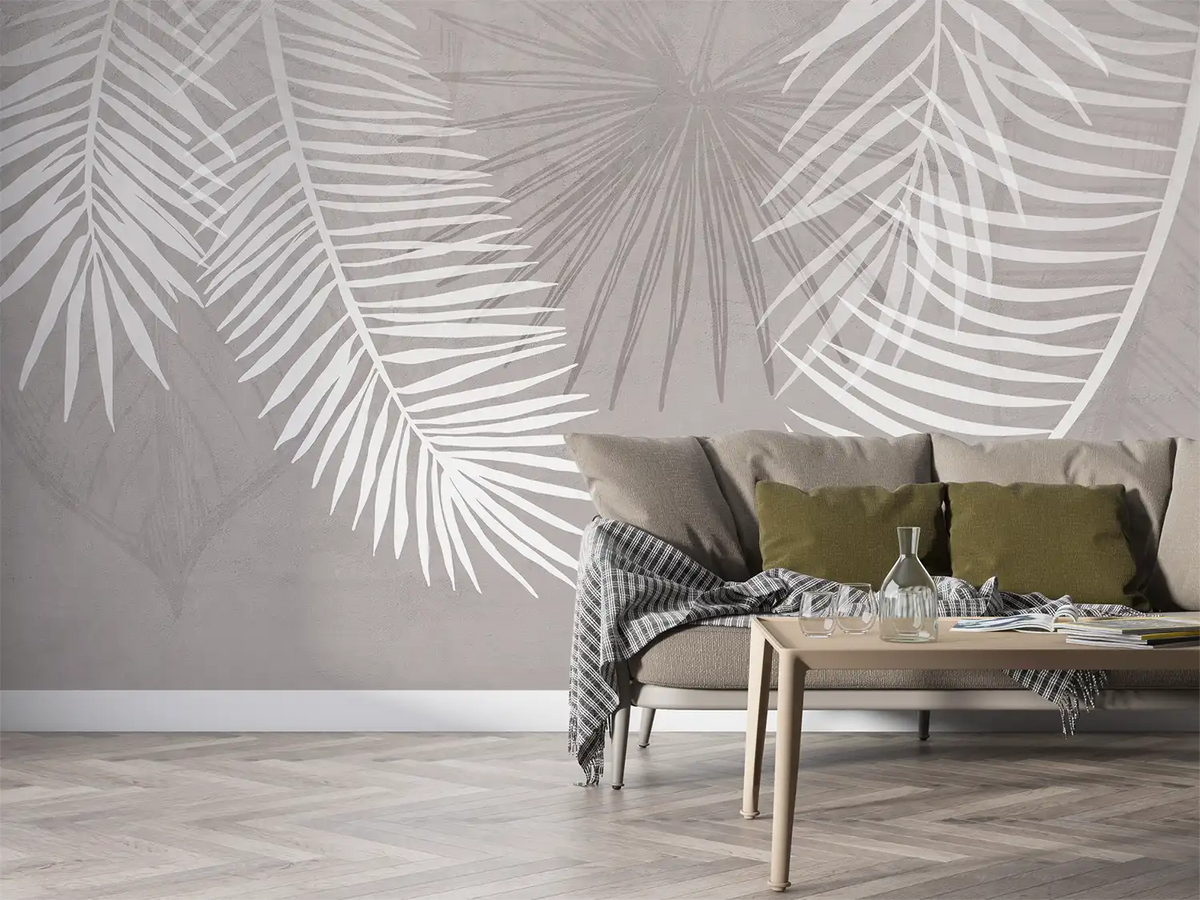 Living room with palm leaf patterned wall and a sofa.